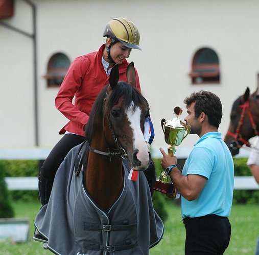 Krzysztof Czarnota gives the PZHKA (Polish Arabian Horse Breeders Society) trophy to Kamilia Tobiasz atop Mu-Zahrat, by Mateusz Jaworski